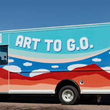 Image of a truck with mountain and cloud designs on it with the text 'Art to G.O.'